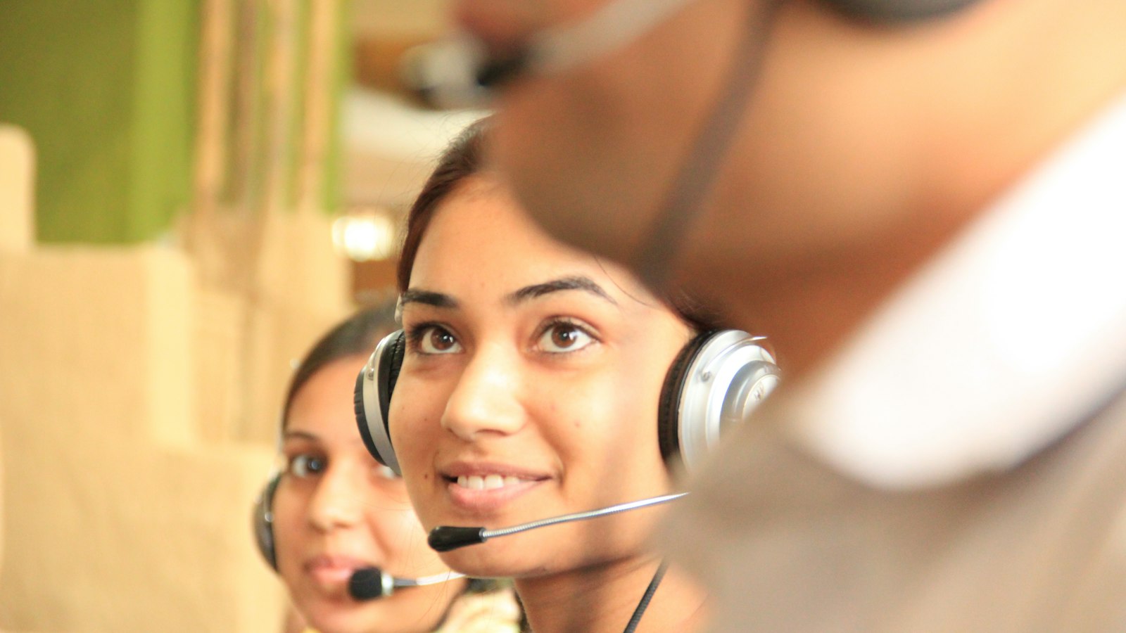 Call center team answering phones, compared with AI answering services