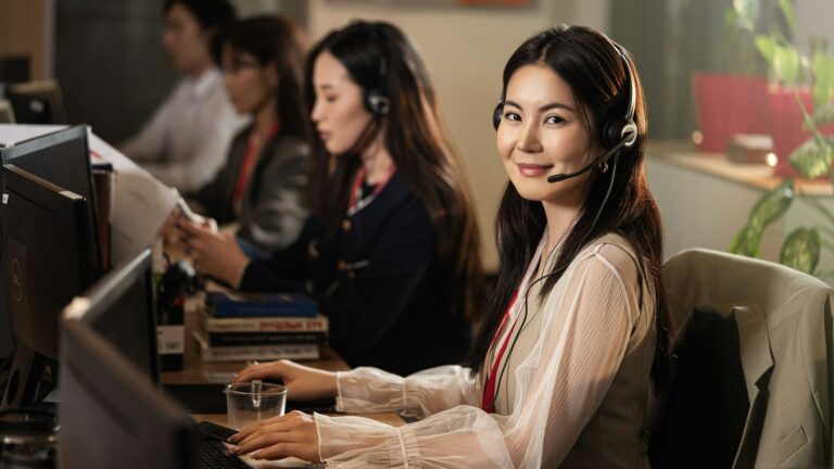 Receptionist wearing a headset answering customer calls for a local service business