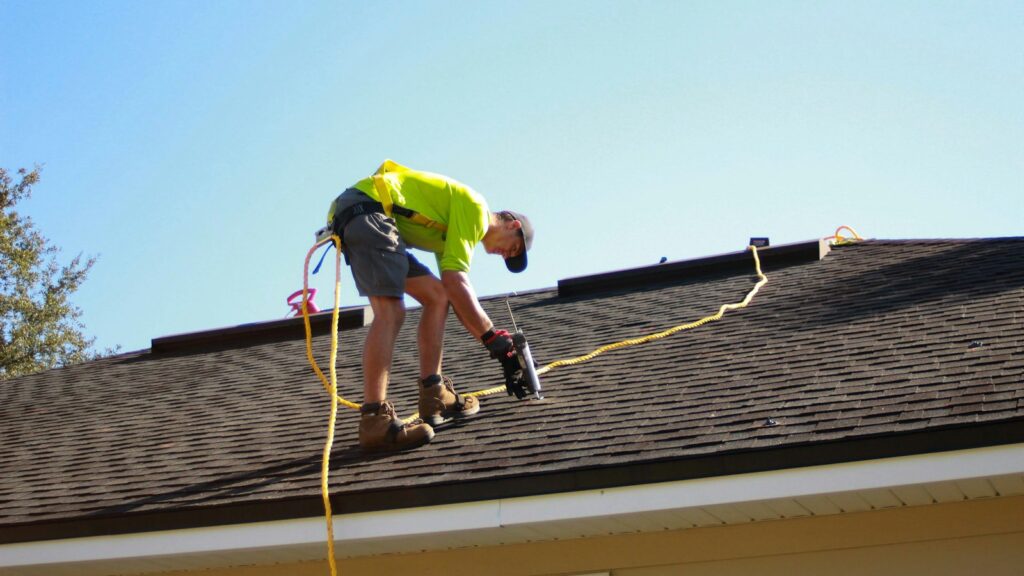 Roofer working on a residential roof, a job generated by Google Ads