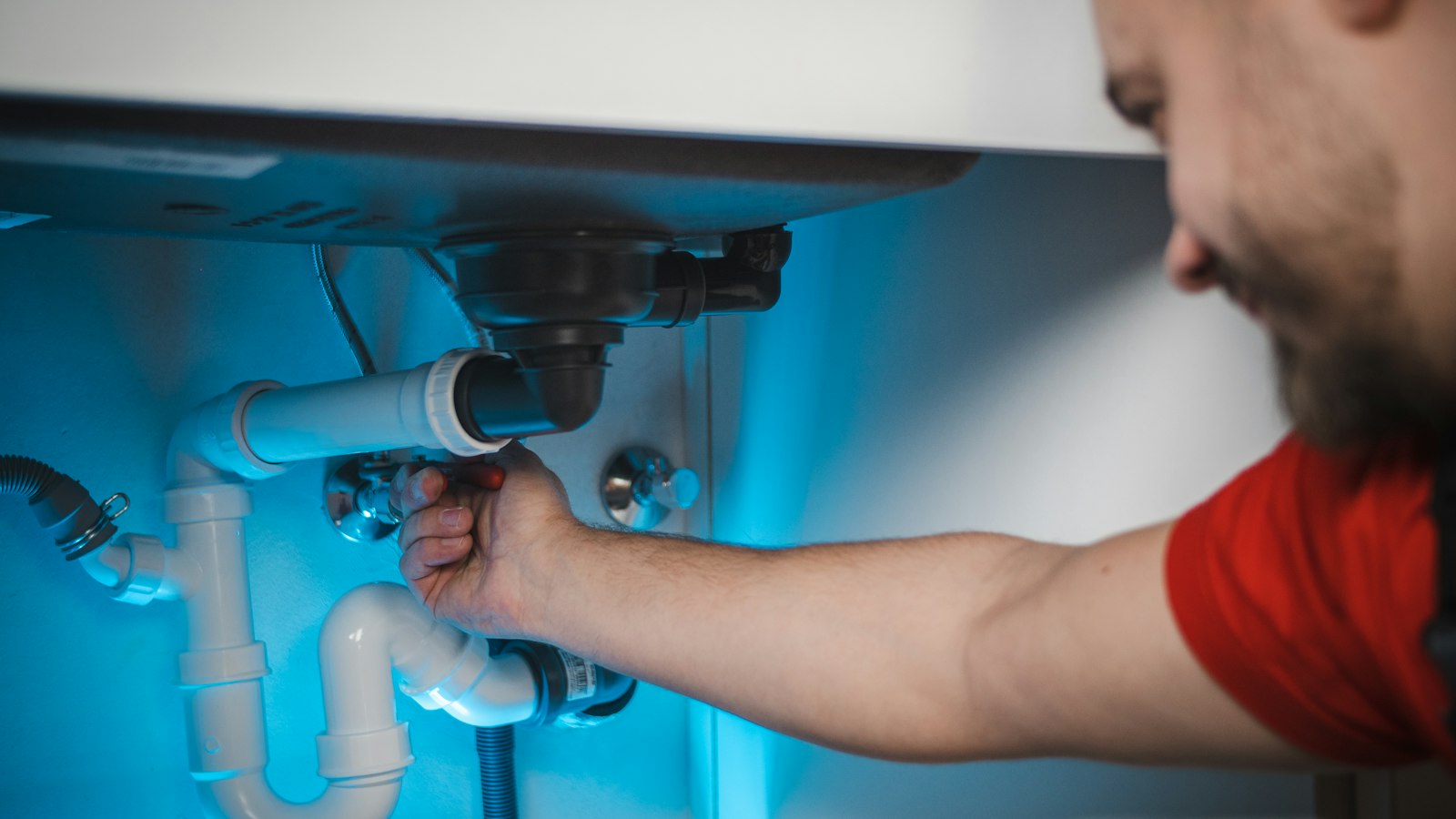 Plumber working on a pipe, a job booked through local search